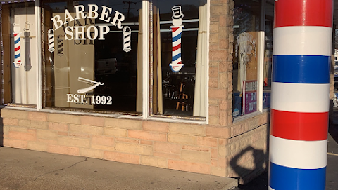 Storefront of Beverly's of Nashville Barbershop on Nolensville Pike with classic barber poles and Barber Shop signage, established 1992